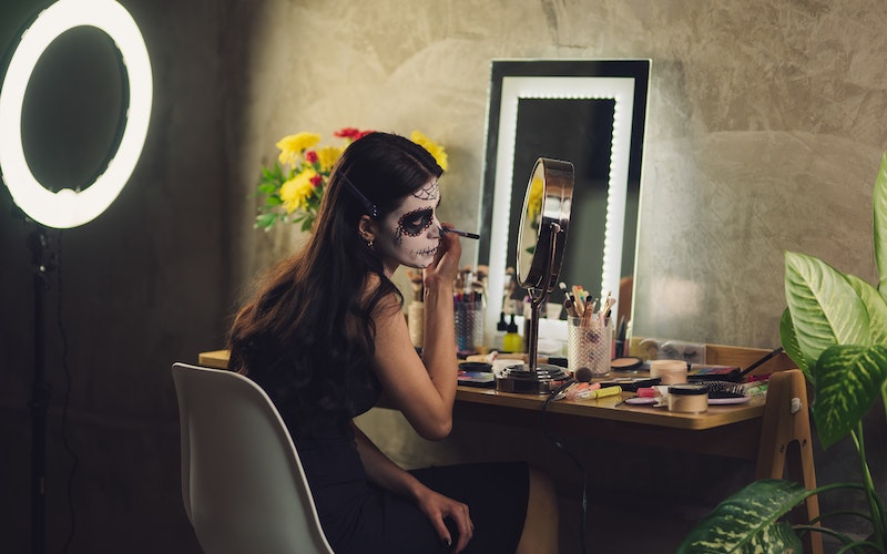 woman applying Halloween makeup