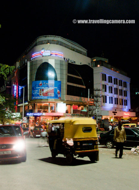 An evening on MG Road of Banglore - During November 2010 : Posted by VJ SHARMA on www.travellingcamera.com : Mahatma Gandhi Road (popularly called as MG Road) is a road in Bangalore, which is capital of Karntaka state of India. It runs east from Trinity Circle at one end to Anil Kumble circle at the other end... Recently I also visited the place and here are few photographs.. : I am sure that I need not to explain about the traffic conditions of the city... I have seen worst traffic conditions in banglore the conditions are not same on all the roads every time but still it wastes lot of time... Few roads inside the city are very narrow and traffic is increasing day by day...MG Road used to be known as South Parade before independence of India. Later it was renamed as Mahatma Gandhi Road during 1948s...Unlike Delhi, cycle-rikshaws are not there in the city. I am not sure about the reason but probably traffic. These slow moving means of conveyance may slow down the traffic further... So Auto-Raikshwas is the only option apart from public Transport.. During the visit I tried  both types of buses which run inside the city.. Normal bus and few AC buses... and noticed and must thing in those buses that driver has the control to open the door whenever it stops at a particular bus-stand. Then it automatically closes and passengers can't open the door... Nice thing which should be a must feature in India...There are lot of good showrooms on MG Road and most of the brands, restaurants are available on one side of the road... We came to MG road during the evening after having a nice visit to Banerghatta National Park... We had some snacks at KFC and started roaming around the places there....MG Road is also one of the busiest roads in Banglore city and is lined on one side with various showrooms, food outlets and restaurants etc. It has many office buildings, shops and theaters as well. MG Road is also a pace to look for large number of buildings and banks...On the other side of the road, Metro work was going on and they had places a model of the metro train which is planned to run on these tracks.... People go to see these coaches and also click some photographs with it....Every one in the city is waiting for Metro to start and improve the connectivity of East Banglore with West part !!! The road has been converted into one way ... Commuters traveling towards MG Road from Anil Kumble Junction will have to turn towards Cubbon Road and go towards Manipal Centre & further on to Trinity Junction due to the construction of Metro Track...The famous Hard Rock Cafe of Banglore !!! Its on the other side of the road....MG Road is adjacent to the Museum Road and perpendicular to Brigade Road... It is also pretty close to a shopping area called Commercial Street...Another Photograph of Hard Rock Cafe from other side of the road in Banglore...A Photograph showing traffic conditions on MG Road of Banglore City...Now it was time to move towards Brigade Road which are perpendicular to MG Road in Banglore.... I will few more photographs spcific to Brigade road and its main attractions... Pub Street n all !!!Mcdonalds in native script of Karnataka.. I saw this first time.... Even companies like Oracle had mentioned their name in Kannada ...