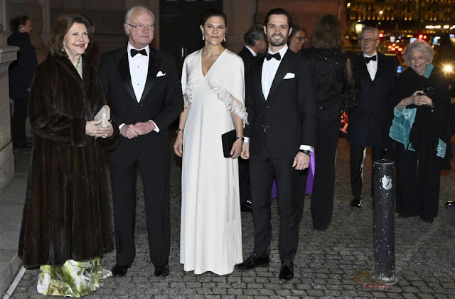 Crown Princess Victoria wore a feather trimmed capelet white satin gown by Toteme. Queen Silvia wore a floral gown