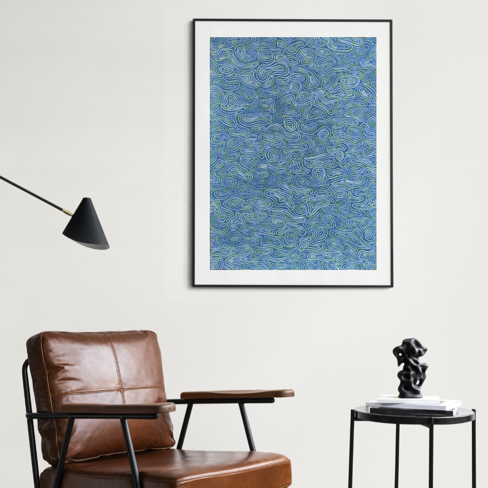 crylic painting on paper is a striking portrayal of water ripples hanging on a wall above leather chair