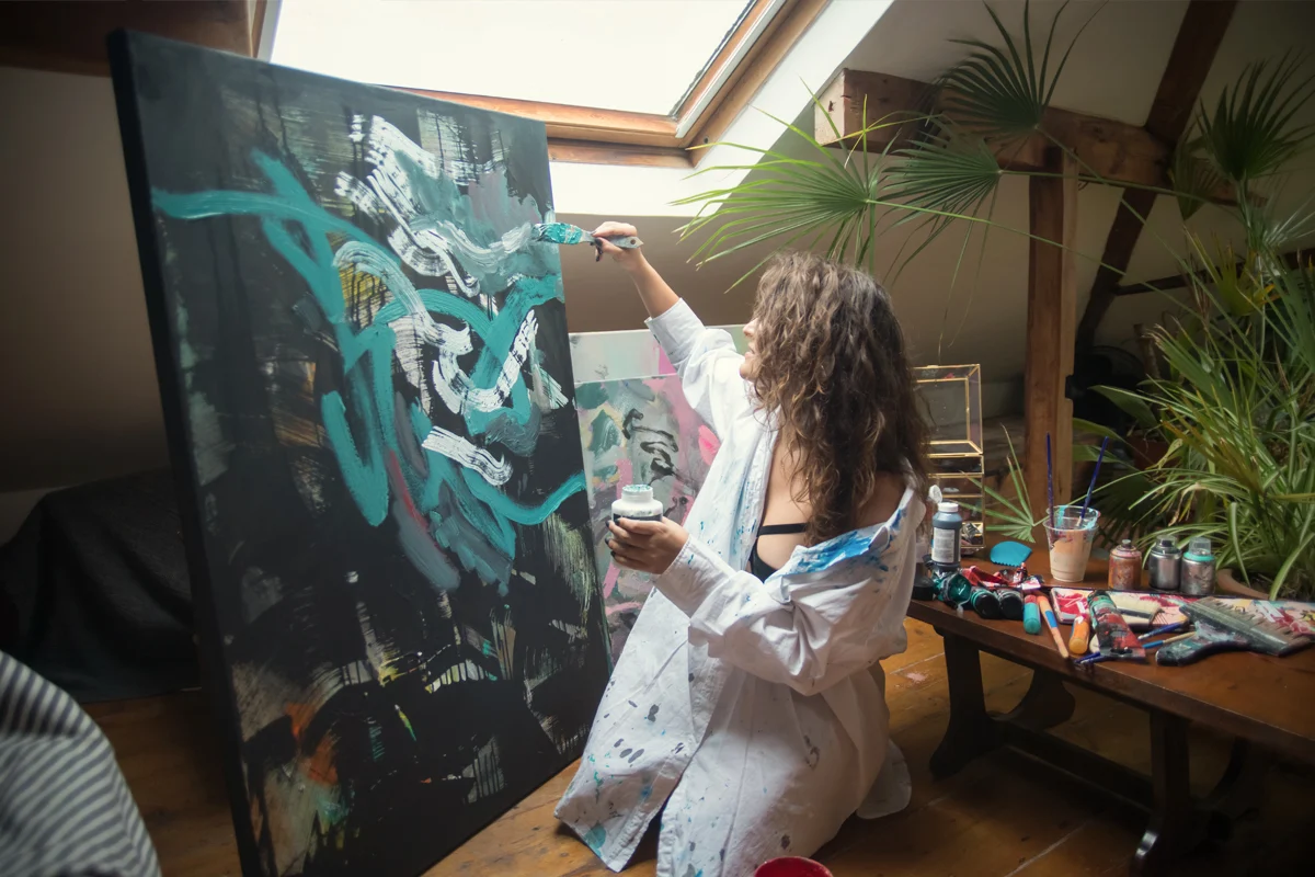 woman drawing in her studio an oil painting