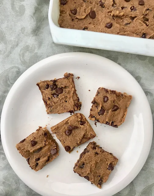 Cut up squares of chocolate chip chickpea blondies on a plate.
