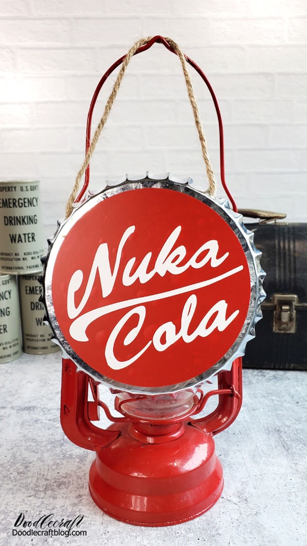 How to Make a Fallout Nuka Cola Bottle Cap!  Make the perfect Fallout themed decor with this easy Nuka Cola Bottle Cap!    I was strolling through the dollar store the other day and found this metal bottle cap hanger...I knew immediately that I had to make a Nuka Cola label for it.   It goes great with all my Fallout themed decorations--and would make a great gift for a Fallout gamer fan!