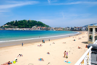 beach bikini girl girls Playa de La Concha with Parte Viejo Old Town in Background  San Sebastian Spain