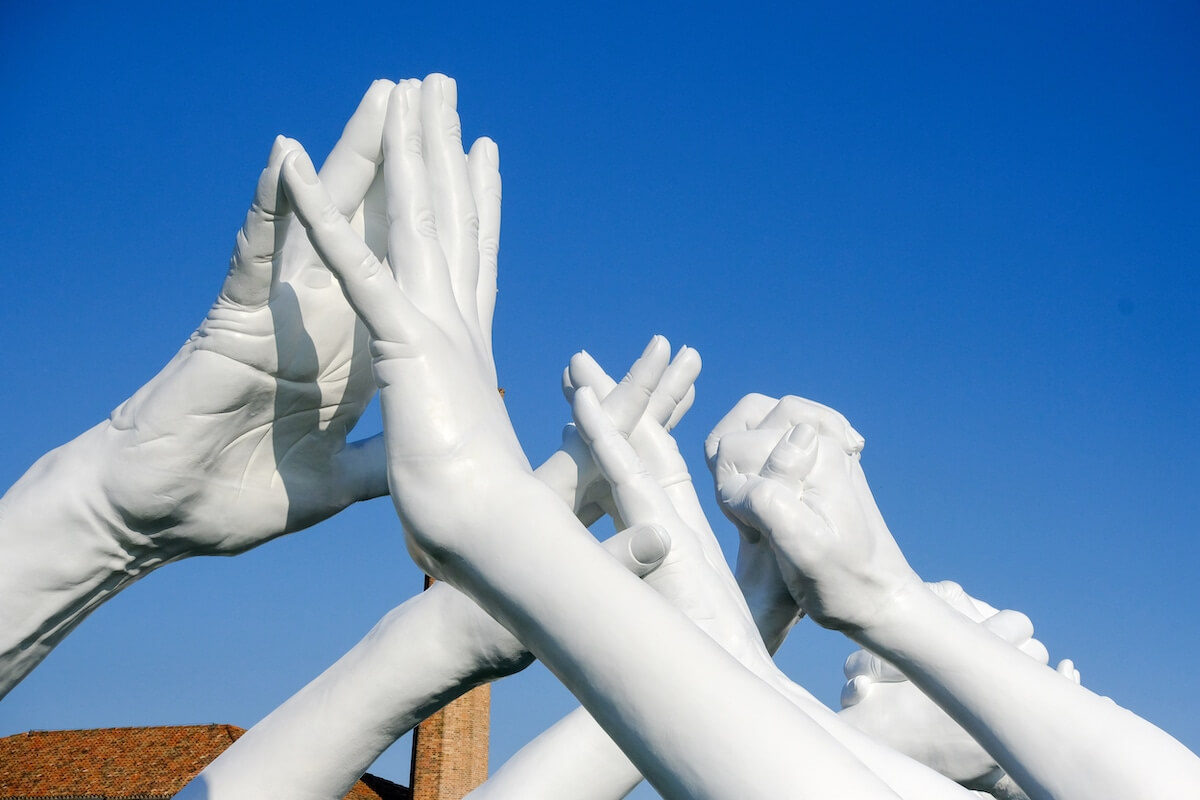 Monumental Installation Of Hands Creating A Bridge Of Unity In Venice