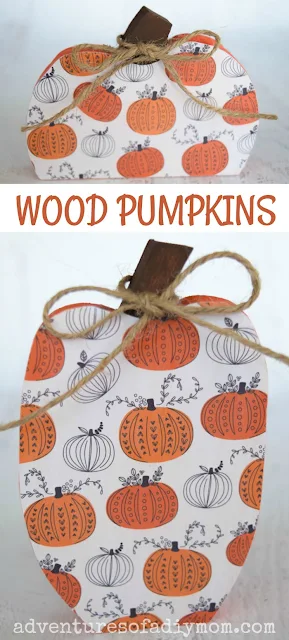 painted wood pumpkins covered with scrapbook paper tied with a piece of twine