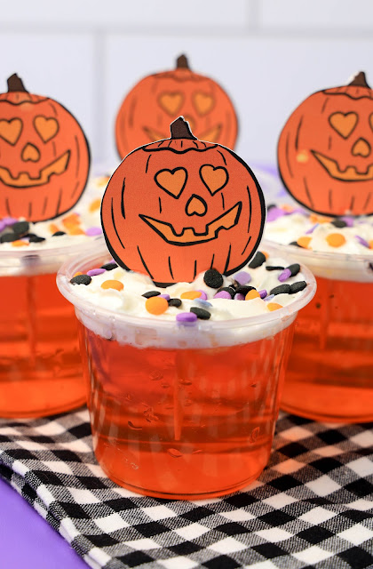Jello Cups on a black and white napkin with purple background.