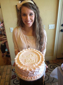 Jill Duggar holding a cake at her wedding shower