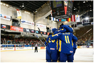 Ottawa Senators prospect Andre Petersson (#20, at left) celebrates with teammates Marcus Johansson (#11, centre) and others.