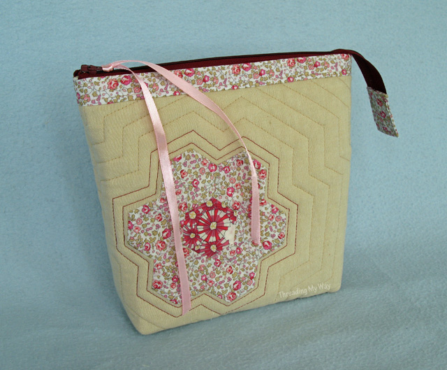 Make a zippered bag with Liberty, hexagons, flowers and echo quilting. Use it as a makeup bag, toiletry bag - lots of uses ~ Threading My Way