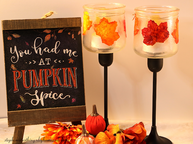 Pumpkin spice sign, fall foliage with mini pumpkins, and completed decoupaged glass jars displayed