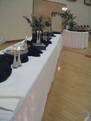 buffet table set up large arrangement in center with delphinium