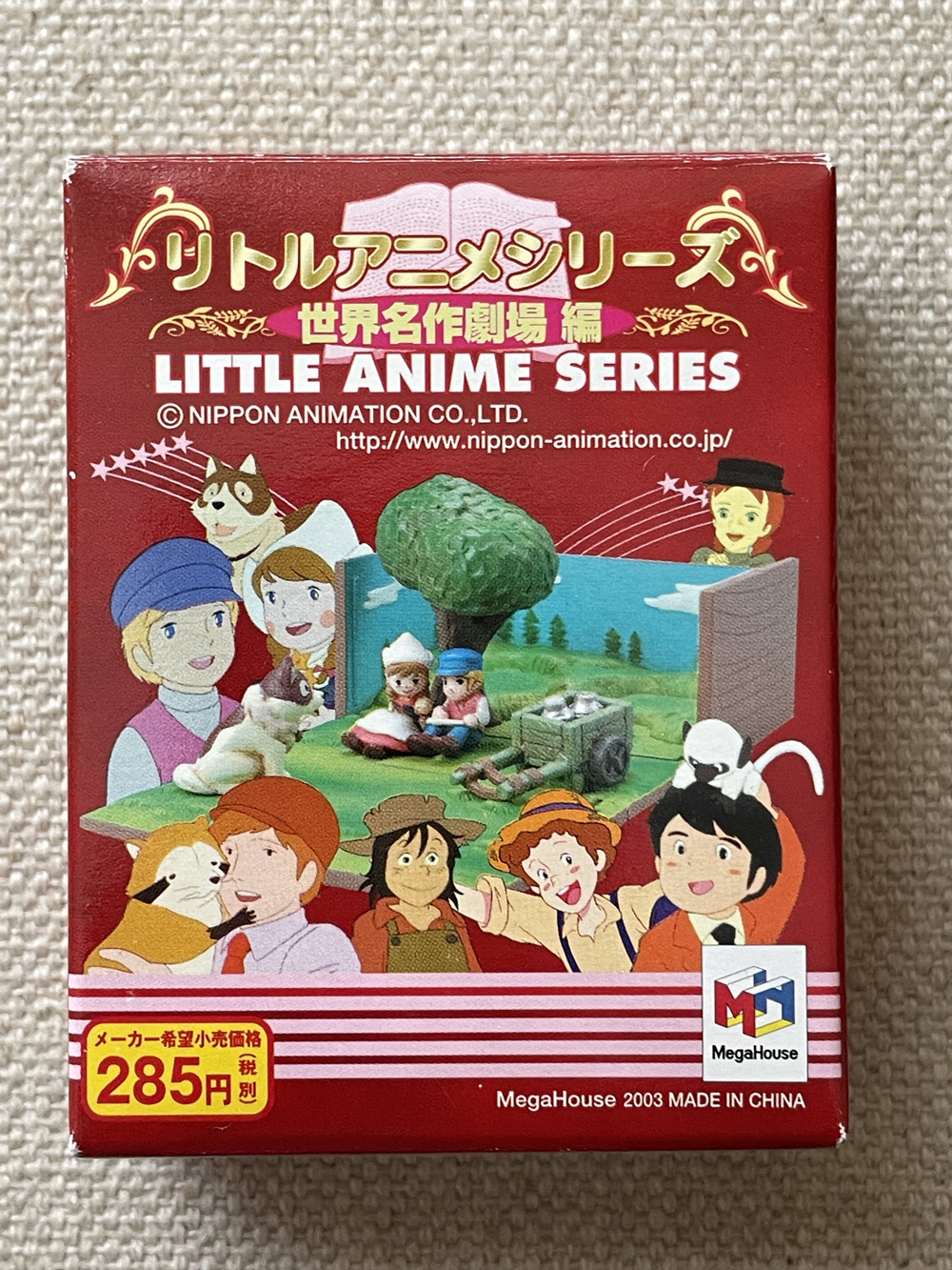 Blind Box containing a Little Anime Series World Masterpiece Theater miniature diorama featuring Anne of Green Gables, 3000 Leagues in Search of Mother, Rascal the Raccoon, A Dog of Flanders, or The Adventures of Tom Sawyer.