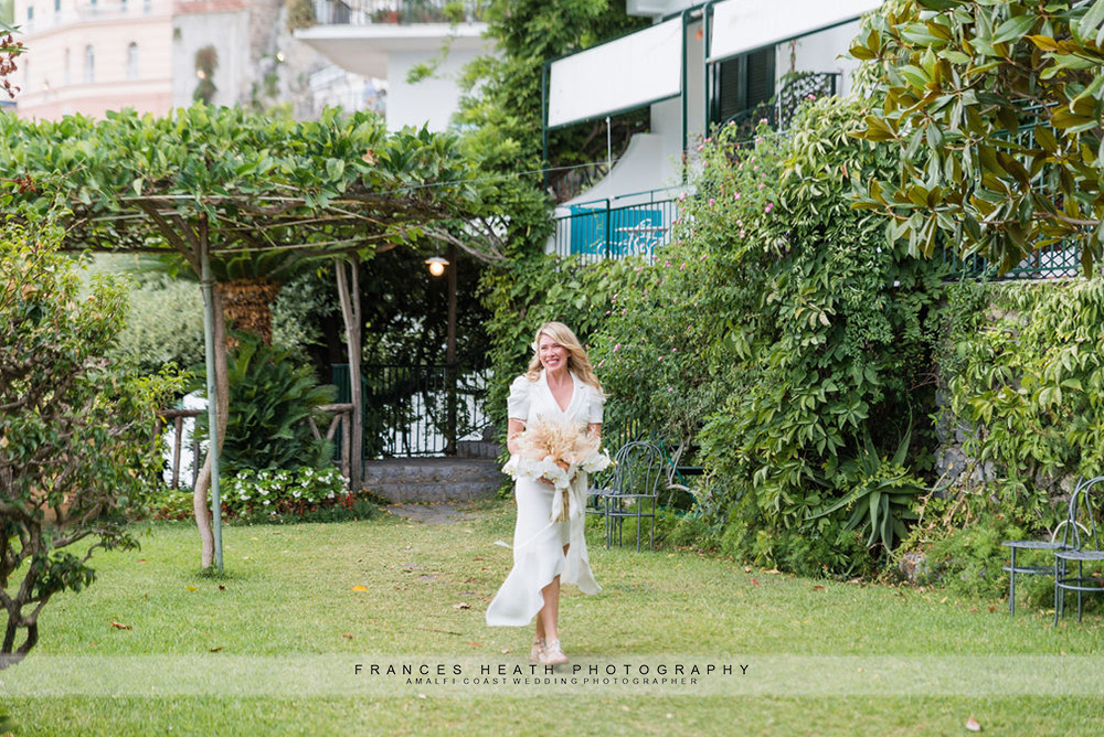 Bride walking down the aisle in the Santa Caterina gardens