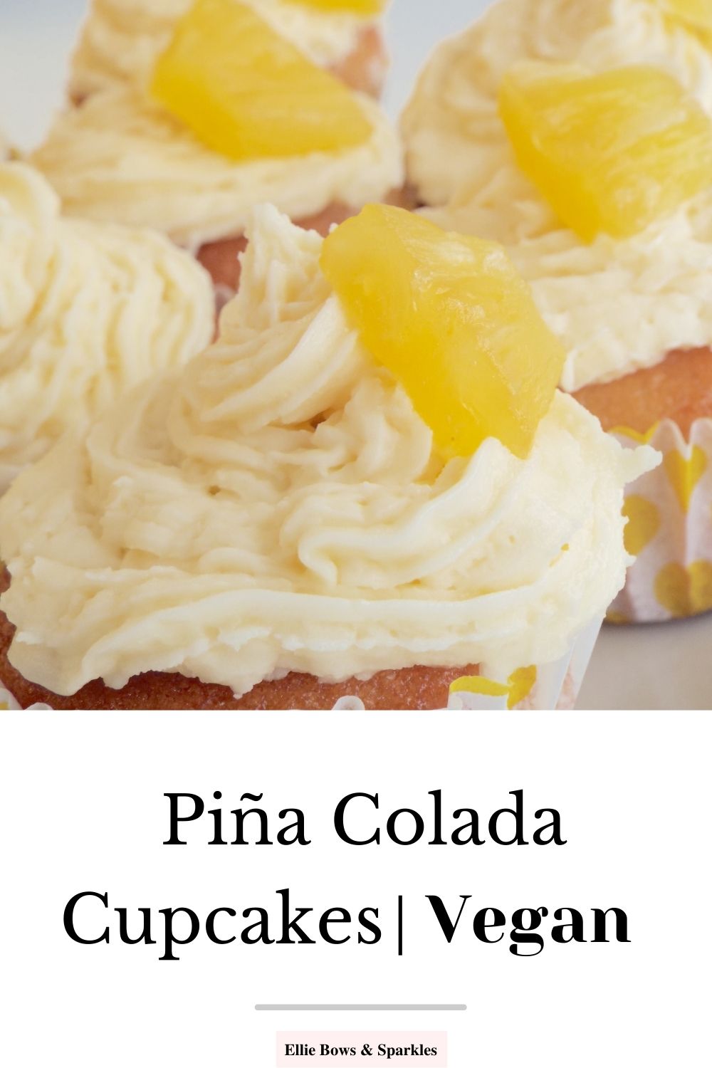 Pinterest pin with close up picture of buttercream swirl iced cupcakes, with pineapple slices on top, with white title box to bottom of pin, reading Piña Colada Cupcakes Vegan.