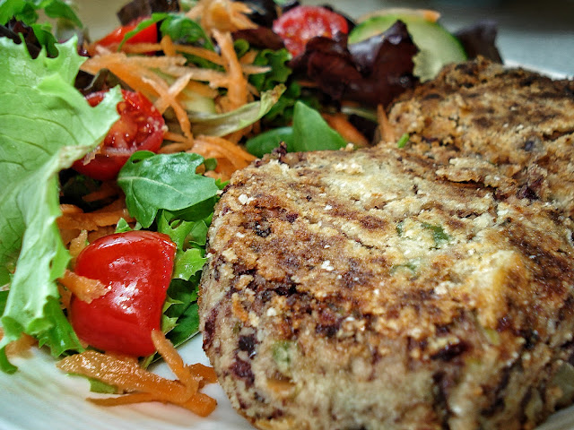 Spicy bean burgers on a plate with salad