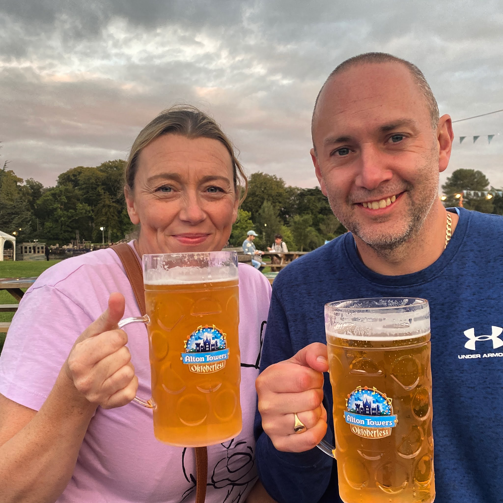 man and woman having a stein of lager