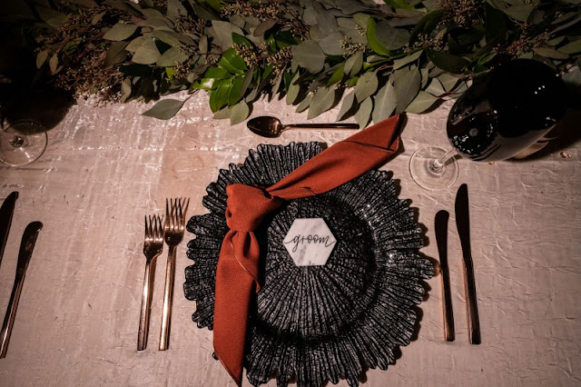 black chargers and red napkin place settings