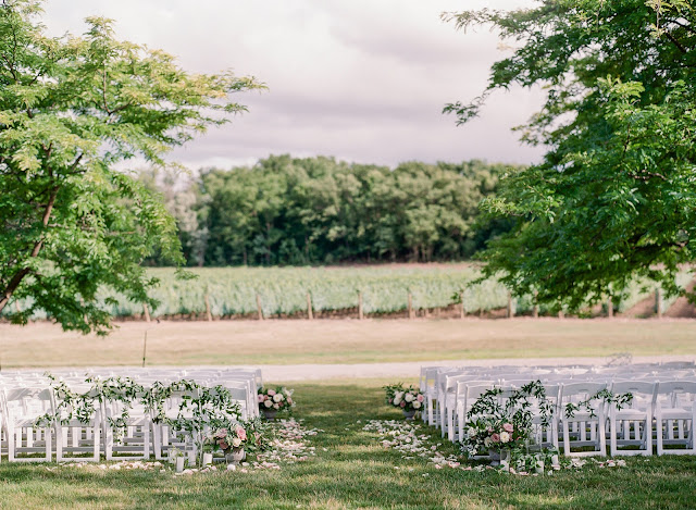 Niagara Wedding Planner | A Divine Affair | Sonia and Tim. Photo by Artiese Studios. Ceremony and Reception at Chateau des Charmes Winery. Getting ready at Vintage Hotels Queens Landing and Photos taken at Niagara Parks Botanical Gardens. Elegant fine art photography with a lot of delicate calligraphy details. Tent wedding reception with the ceremony outside in front of vineyard.