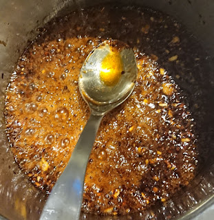 Adding all the sauces to the garlic and red pepper mixture