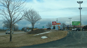 back end of a storm front above fast food restaurants