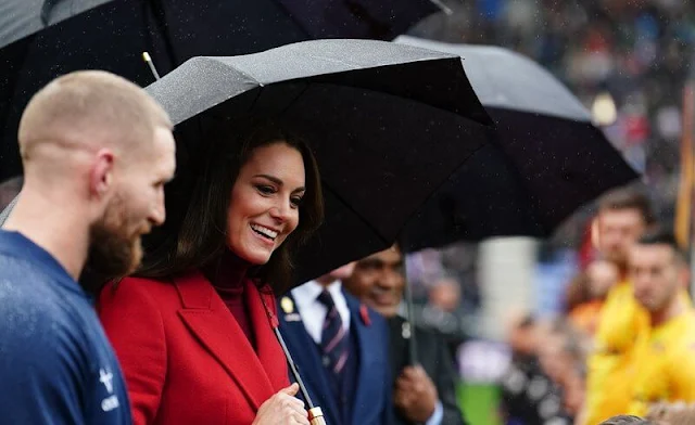 The Princess of Wales wore a red coat by Alexander McQueen, and a dusty red pleated skirt