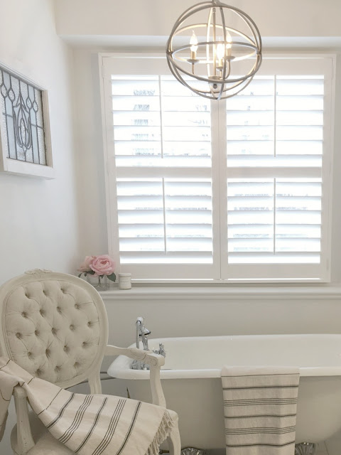 Beautiful white bathroom with classic style by Hello Lovely Studio