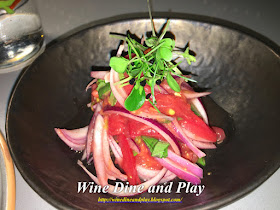 The Uzbek artichoke salad has tomatoes and red onion served with polov dish