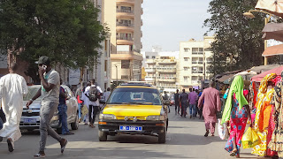 Many people in all colors walking around in Dakar Markets and sell stuff