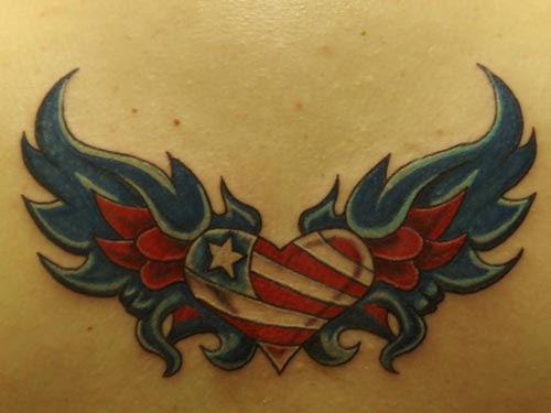 Red heart tattoo accessorized with thunder, flower and banner on 