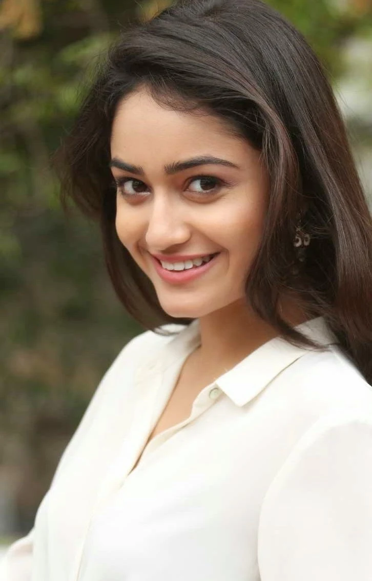 Glamorous Bengali Girl Tridha Choudhury Long Hair Photos In White Dress