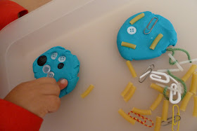 Playdough decorated with little bits and pieces