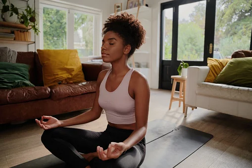 Young women doing yoga in home