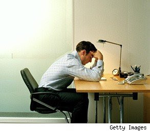 Wrong Career Choice: Man sitting and leaning on a table dejectedly