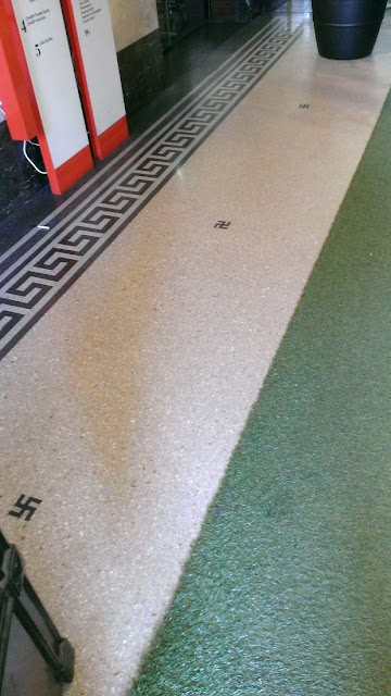 Small black swastikas and meander key fret on the floor of the Customs House in Sydney, Australia.