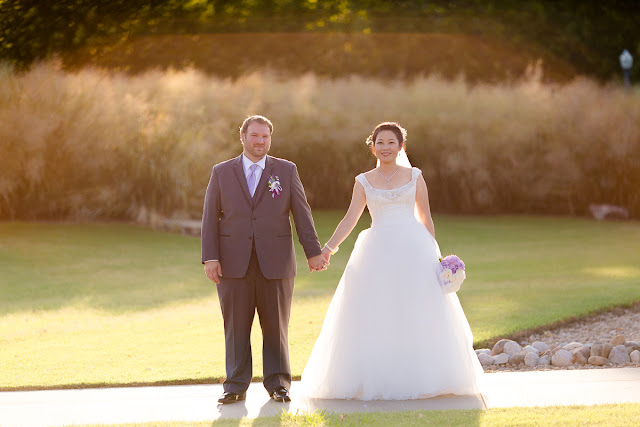 On a day in early September the sun is low in the sky.  Together, they hold hands and face forward.  They have become husband and wife today.  Taken at the Sam Noble Oklahoma Museum of Natural History in Norman, OK.