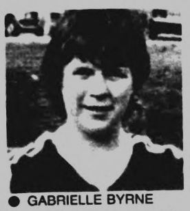 Black and white image of the head and shoulders of a smiling woman in a football kit