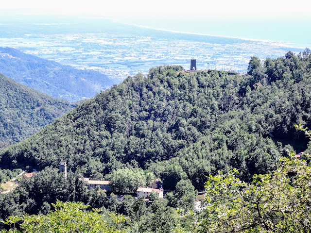 in basso a sinistra la chiesa di S. Anna di Stazzema - in alto sulla collina il Monumento Ossario