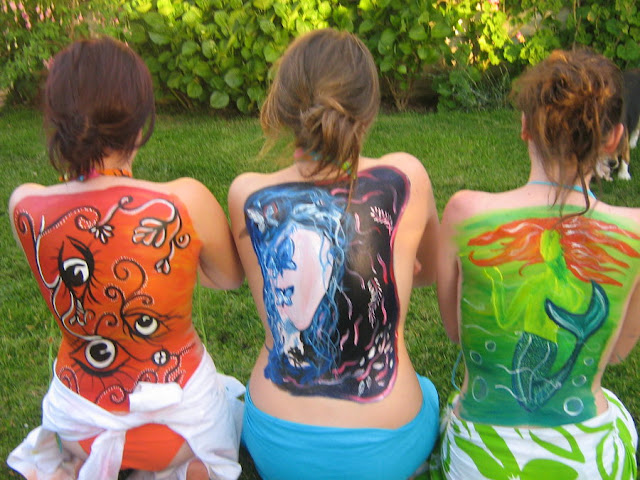 girl full body paint on his back