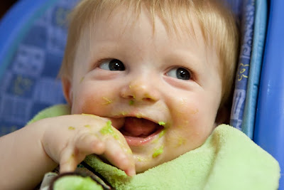 baby eating solid food