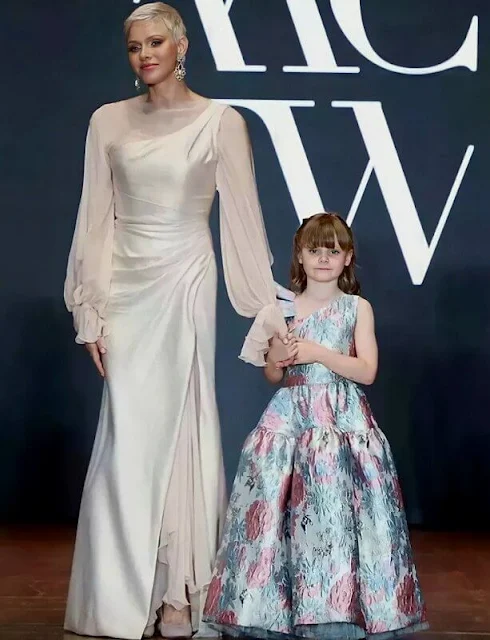 Princess Charlene and Princess Gabriella wore custom-made gowns by Terrence Bray. Repossi jewels pearl and gold earrings