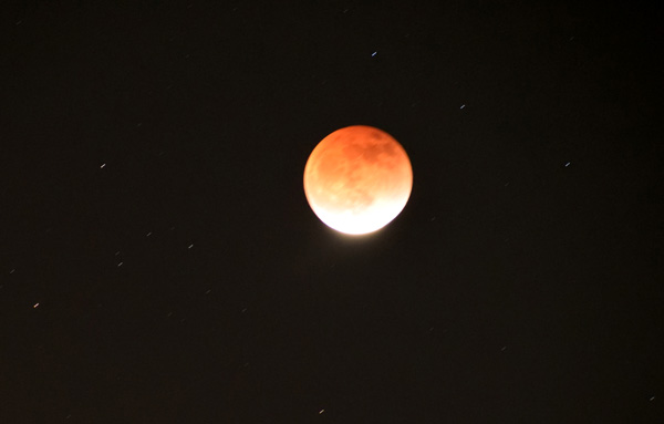 The Moon begins to emerge from Earth's penumbra, or lighter shadow, as the 85-minute-long total lunar eclipse is about to conclude on May 15, 2022 (Pacific Time).