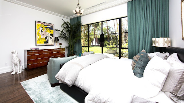 Guest bedroom mansion wood floor turquoise curtains picture window wood drawers black leather bed