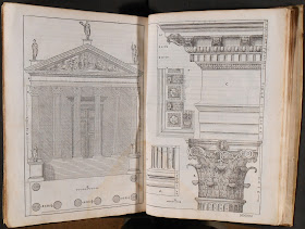 An open book of architectural drawings.