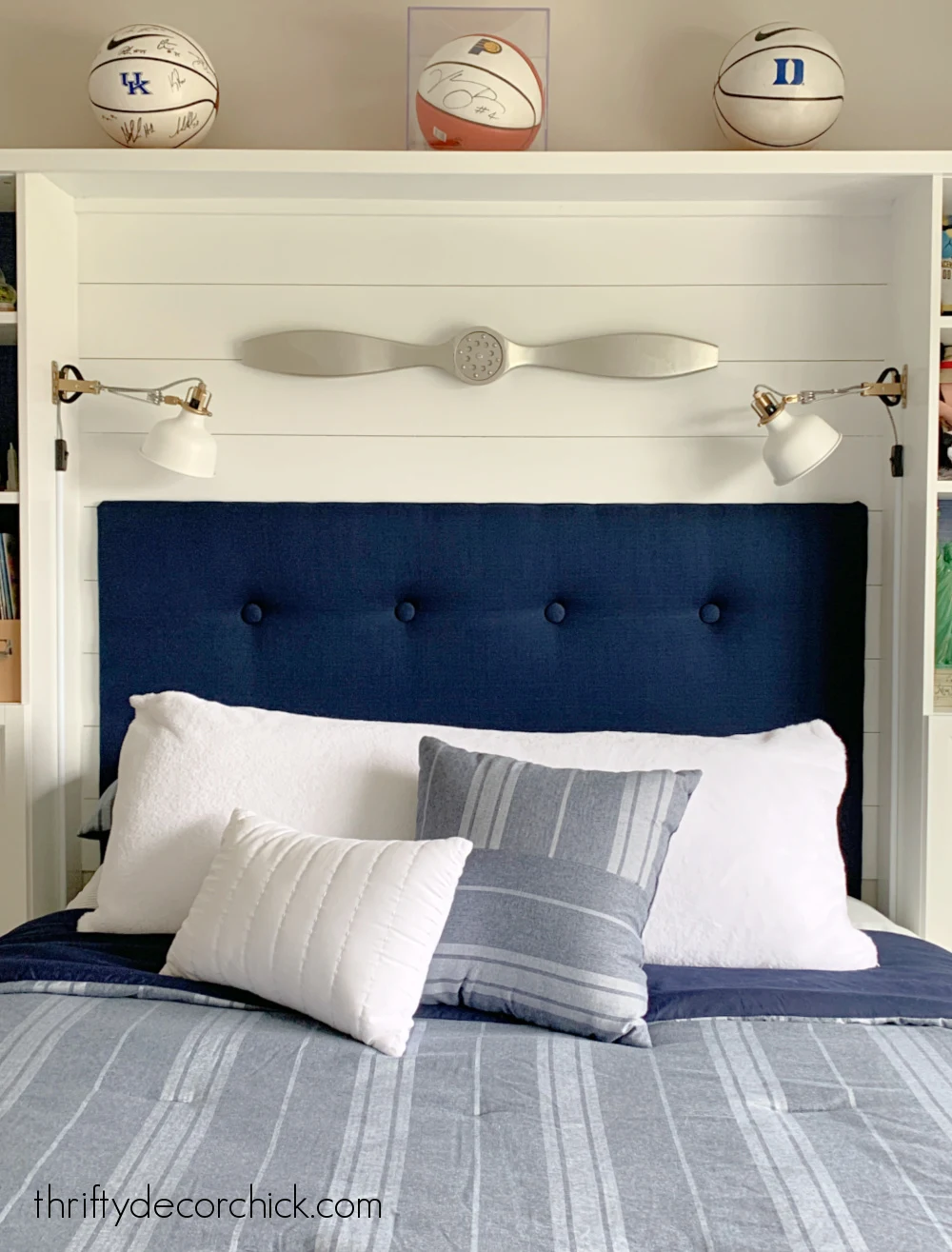 bed nook with sconces and headboard