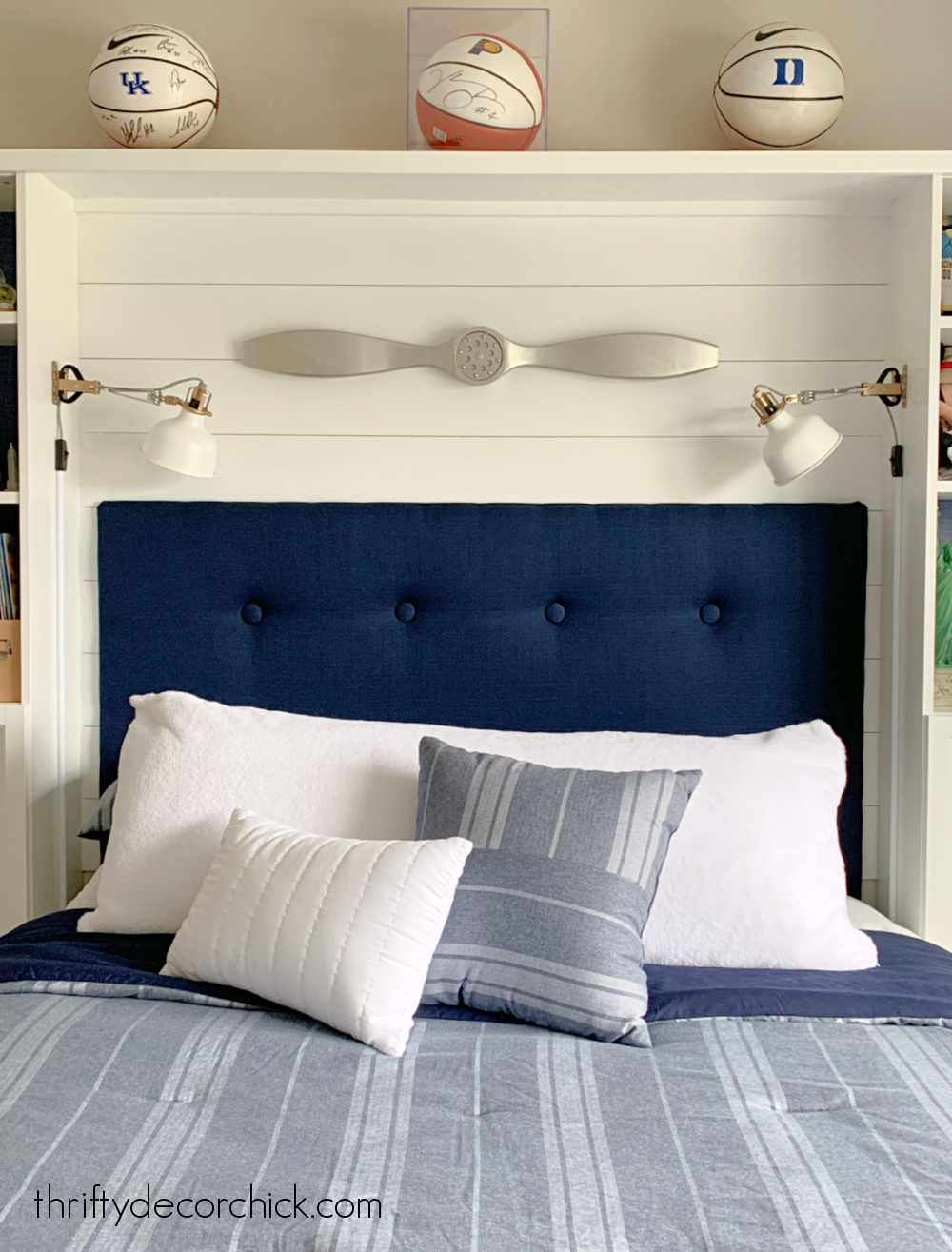 bed nook with sconces and headboard