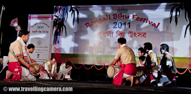 Huchori Performance by an Assamese group of boys @ Rongali Bihu Festival, IGNCA, Delhi : Posted by VJ SHARMA on www.travellingcamera.com : Huchori - Huchori is an integral part of Rongali Bihu. Choral parties of singers and dancers moving from house to house is a salient feature of Rongali Bihu !!!Huchori is a regular thing which happens during the Rongali Bihu and it is a custom of community singing in which a group of singers visit each home in their locality and sing songs containing spiritual and moral values. The group comprises only of men and the event coincides with the Assamese New Year. The group visits every house irrespective of caste, creed and social status of the householder. During the reign of the Ahom dynasty, Huchori singing was a usual custom in the royal palaces. At a later period it began to be practiced by common people.A group of boys performed Hichuri on the stage and it was really interesting to see overall getup of folks in the groups and it seems elder folks also join this group to better guide the younger ones :) .. Although I was not able to make any sense out of the songs or dialogs, but it looked very interesting !!!Huchori group begins its procession from the village headman’s house and continue towards the other houses in the vicinity. The procession proceeds amidst chanting, singing and dancing. Visiting each house in the village, the group accepts some donation from the residents. The singers usually carry a staff, a bag, an umbrella and a lamp while roaming around the village. Their instruments comprise of dhol (drum), taal (cymbals), pepa (horn pipe) and taka (bamboo clapper).This seems more like Lohri in North India.. Specially in Punjab and Himachal Pradesh !!! On Lohri week, boys make some groups and start visiting various houses in the village/town and sing different Lohri Songs... After that every house master offer some stuff like wheat, corns or rice.. and now people prefer to give money.. as it's convenient for both parties :)Huchori Performance at Rongali Bihu Festival in Indira Gandhi National Center of Arts was amazing and the energy level of folks performing was commendable !!!Here is one of the most enthusiatic performer of Hichori Dance who was handling dhol during Riganli Bihu in Delhi !!!Notice the dressed of all these folks and they have taken proper care of clothings they should use !!!Although I was not able to make out anything as they were singing in Assamese but their expressions were telling a story !! Here a couple is presenting something for god and praying for good !This whole event was organized by Assam association Delhi in partnership with Indira gandhi National Center of Art and it was wonderful experience at Rongali bihu festival !!!