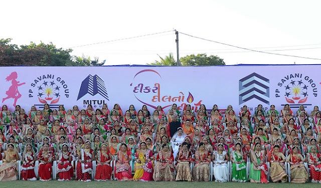 Participants pose for a photo at the mass wedding of 236 fatherless girls organised by the charitable PP Savani Group in Surat, some 270 km from Ahmedabad