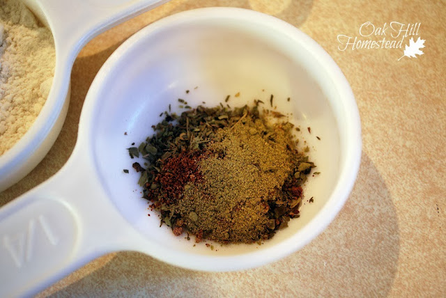 Spices for soup, measured out ahead of time, in a white measuring cup.