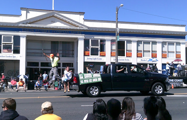 man jumping out of the back of a truck at a parade